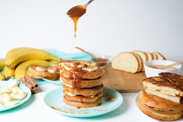 French toast with banana and homemade caramel with cinnamon, Breakfast dessert on a blue plate on a...