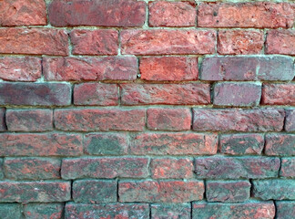 The red brick walls of a large background texture
