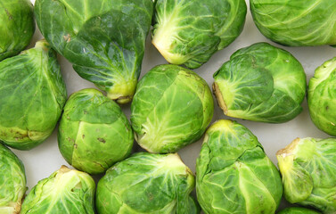 freshly brussel sprouts and some whole ones on a white background