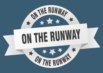 on the runway round ribbon isolated label. on the runway sign