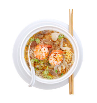 Asian noodle soup with fungus and shrimp in front of white background