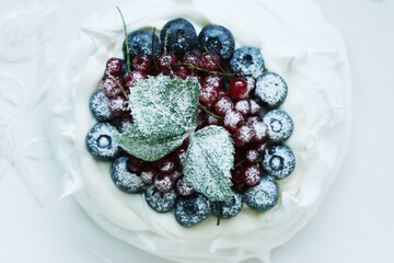 Obraz na płótnie Canvas Anna Pavlova dessert with blueberries and red currants