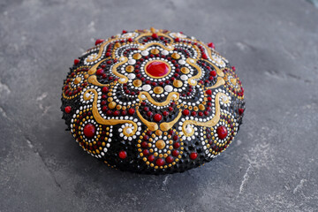 beautiful mandala rock on concrete background