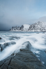 Long exposure of the ocean with mountains in the background