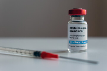Bottle of interferon and syringe (artistic rendering)