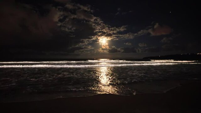 Full moon rising over sea waves. Dramatic sunset over beach video