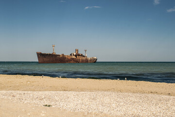 Wreck on the sea.The rusty wreck of an old industrial ship.