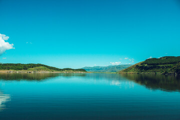 blue reservoir under blue sky