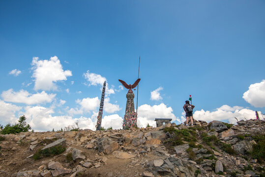 Harghita Madaras, Romania- 08 August 2020: Tourist admiring the bronze hungarian turul bird symbol on the top of the mountain.