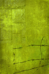 Green grunge wall with barbed wire