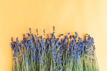 Bunches of lavender on a yellow background. Above is the place for your text.