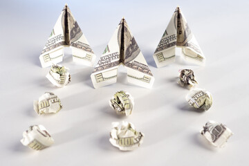 Throwing money to the wind. Paper airplanes and an inversion trail made of dollars. Bills are used...