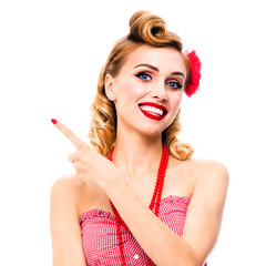 Happy smiling beautiful blond woman pointing at something. Pinup girl showing copy space for text. Retro fashion and vintage studio concept picture. Isolated over white background. Square image.