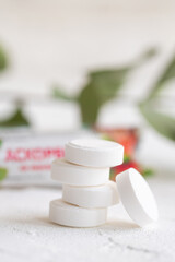 Vitamin C tablet on white background. White pills of ascorbic acid