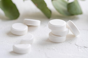 Vitamin C tablet on white background. White pills of ascorbic acid