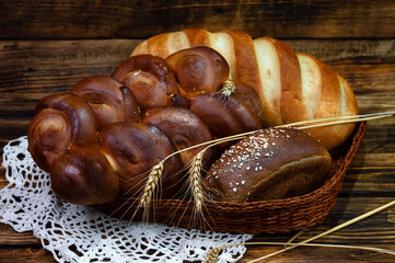 Assortment of fresh bread on a wooden background..