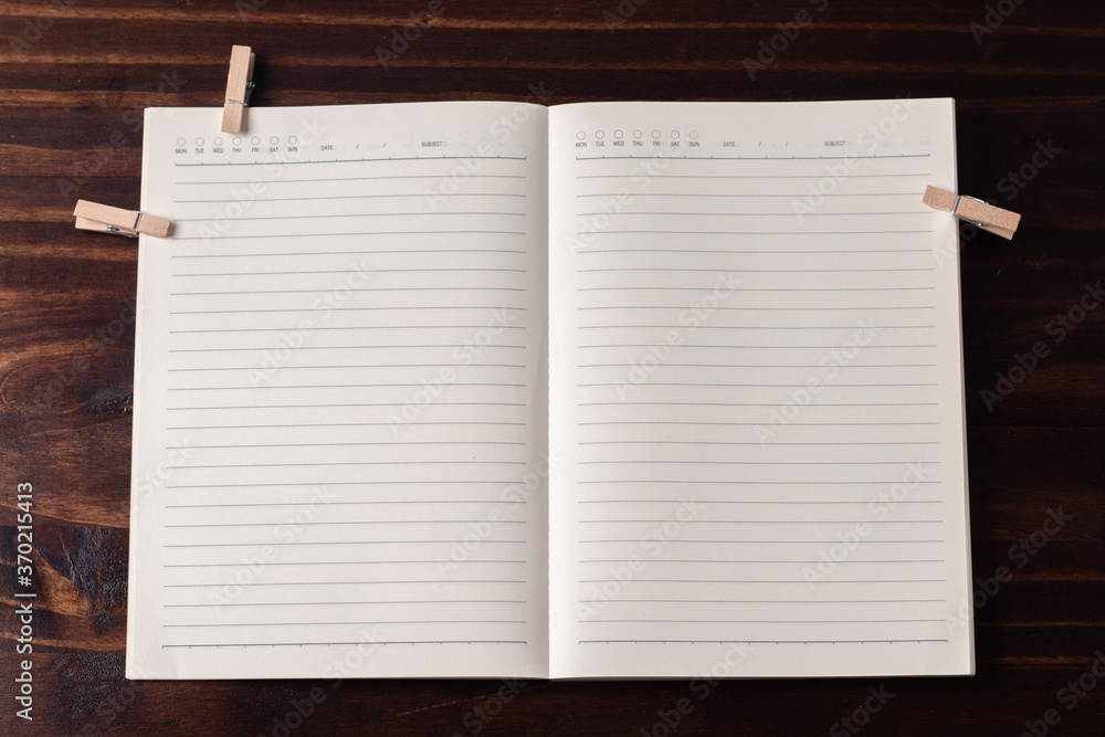 Poster notepad with lines on a wooden background. copy space.
