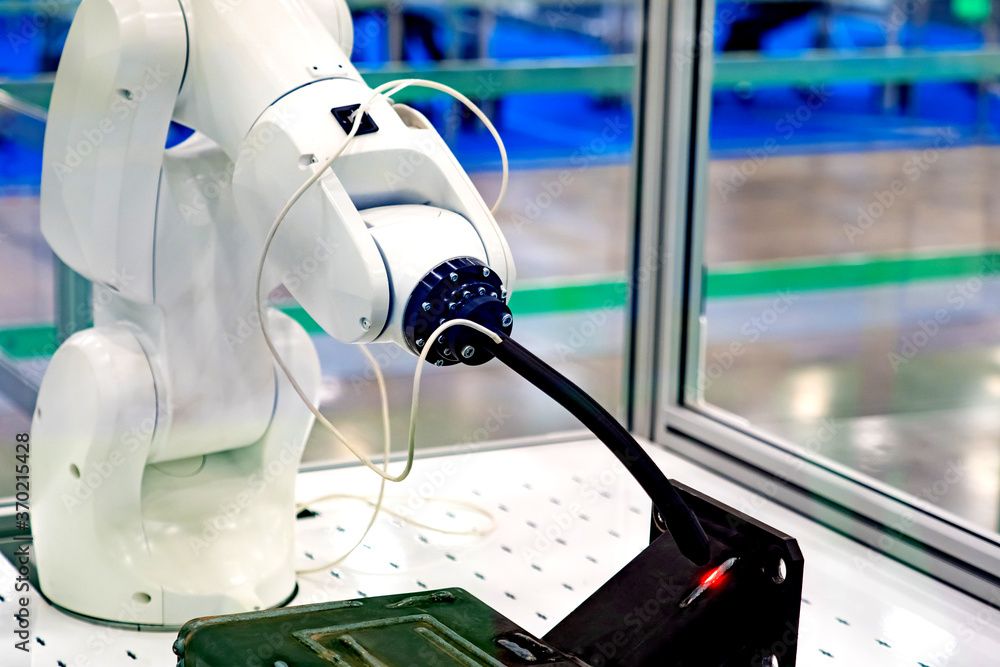Poster robot for the welding of metal parts. the welding robot is tested in the laboratory. welding is perf
