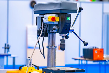 Vertical drilling machine close-up. Drill press with a vise. Equipment for Metalworking. Drilling equipment in the workshop. Machine for drilling holes in metal parts.