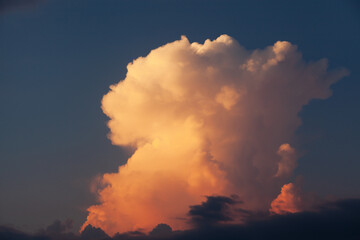 Fototapeta premium Clouds on the background of pure nea at sunset