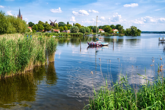 Colorful sailboat in front of a little river island, witch is part of the town Werder, Havel