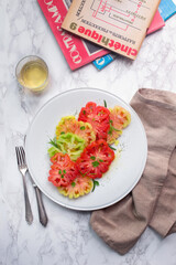 Still life with plate of tomatoes, wine and movie magazines