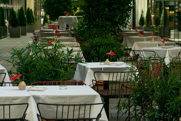 empty tables in a cafe on the street without people and customers