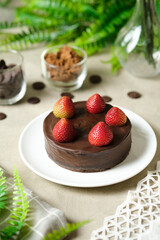 Mousse chocolate cake with strawberry. set on cafe table.