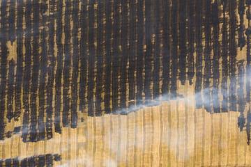 Farm field in fire, aerial view. Burning agricultural rye field with smoke.