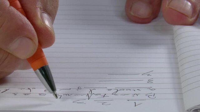 4k 50fps Man's hand makes some annotations on a diary