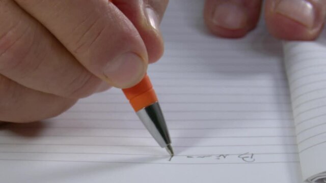 4k 50fps Man's hand makes some annotations on a diary