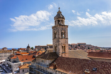 Fototapeta premium Church tower of Dominican Monastery (Dubrovnik Dominikanski Samostan, 1225) and the orange-tiled roofs of old town. Dubrovnik, Mediterranean, Croatia.