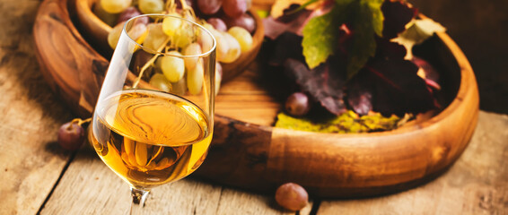 Dry white wine in glass, old-fashioned still life, banner