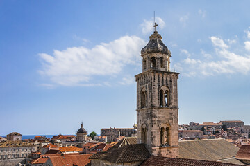 Fototapeta premium Church tower of Dominican Monastery (Dubrovnik Dominikanski Samostan, 1225) and the orange-tiled roofs of old town. Dubrovnik, Mediterranean, Croatia.