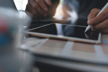 Interior designer or decorator using stylus pen on digital tablet working in office