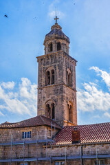 Church tower of Dominican Monastery (Dubrovnik Dominikanski Samostan, 1225) and the orange-tiled roofs of old town. Dubrovnik, Mediterranean, Croatia.