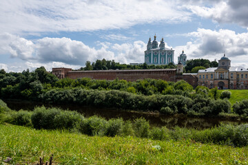 city view with old buildings and green trees and a river
