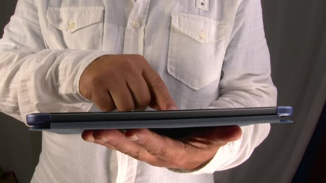 4k 50fps Man consults a tablet by sliding his fingers on the glass