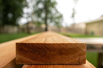 Cedar wood planks being cut for pergola. 