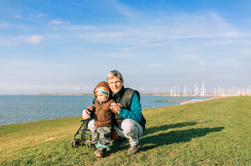 Man with toddler girl on dyke of IJsselmeer