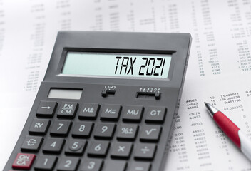 A calculator with the inscription tax 2021 . Business profit concept