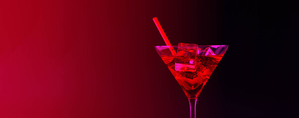 Red refreshing cocktail with ice cubes prepared by the bartender