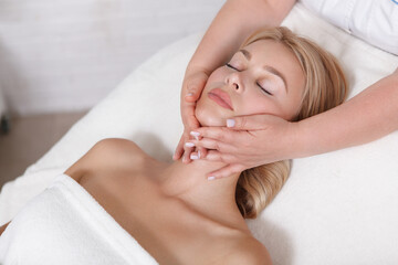 Top view close up of a beautiful woman enjoying face massage - obrazy, fototapety, plakaty