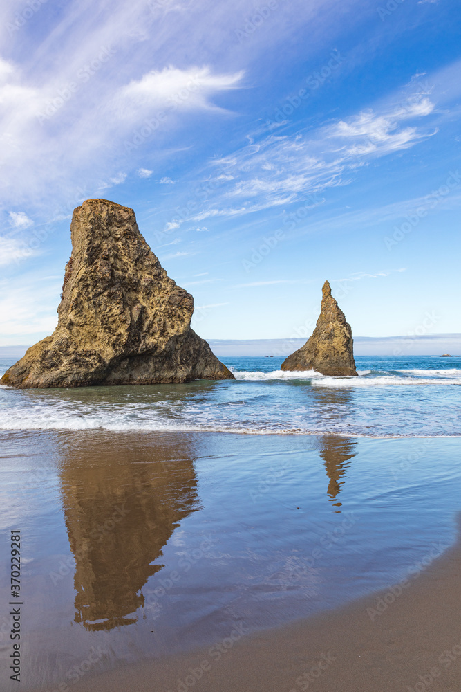 Canvas Prints vertical image- sea stacks reflecting in the water on bandon beach with interesting clouds above in 