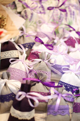 Multi-colored bags of linen with lavender, decorated with white, lilac and purple lace and ribbons