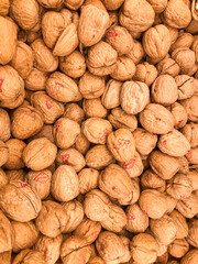 A pile of walnuts on sale in a shop.