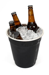 A black ice bucket with four brown glass bottles of beer on a white background.