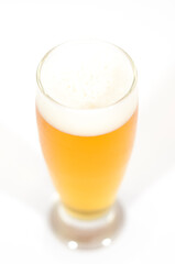 A glass of beer filled with foam centered in the image with a white background.