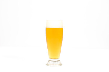 A glass of beer filled with foam centered in the image with a white background.