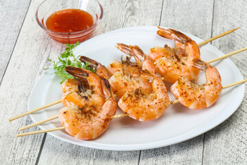 Grilled prawn skewer with sauce